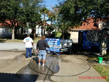 Photos from Popa Construction LLC Before & Afters of a soft wash roof cleaning and driveway and side walk cleaning.