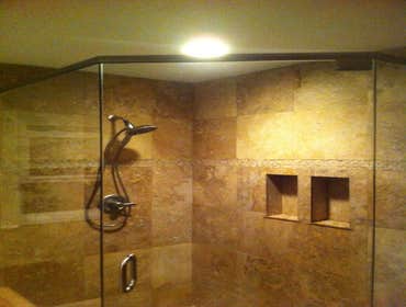 Frameless shower enclosure