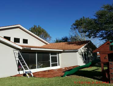 Photos from Popa Construction LLC Before & Afters of a soft wash roof cleaning and driveway and side walk cleaning.