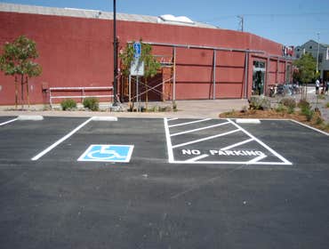 The Bicycle Trip in Santa Cruz Ca layed out and striped new parking lot.Including signs and wheel stops.