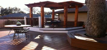 Custom composite deck with cedar arbor, amenities Custom Trex deck, multi level, with raised cedar arbor dining area, three cedar side planter boxes, b