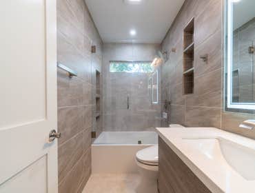 Custom Bathroom Addition | San Jose This San Jose custom bathroom addition introduces a warm-toned, modern space designed for both efficiency and comfo