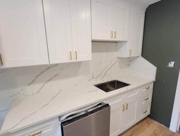 Photos by Infinite Floors & More #2 Full kitchen remodel. Full height backsplash quartz, custom cabinets, new LVP flooring, new trim!