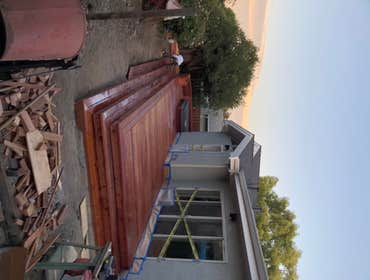 Photos by Jr Aki Carpentry Back Yard, Redwood deck around hot tub, with wraparound steps, planter boxes, with built in drains that tie into storm drai