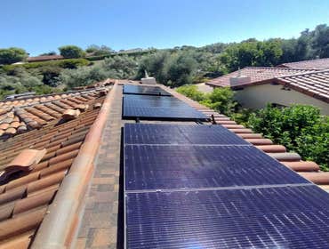 6.8 kW Solar Installation (Santaluz, San Diego) 6.8 kW solar array on asphalt-shingle roof surface under solar - terracotta tile inlay following comple