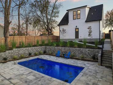 Backyard pool, retaining walls, and carriage house studio crafted during the full restoration and addition by CJMC Build in 12 South, Nashville.