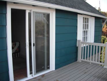 Stone House Remove cabinets and window, add wall closet to bedroom, install sliding door, tile on inside of slider, add secound story deck to front of 