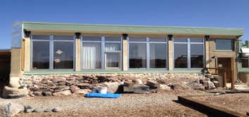 Little House Rammed Earth and Earth sheltered contemporary home. Passive solar heating, thermal mass, water harvesting and PV power system.