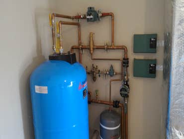 Photo(s) from Radiant Floor Heating Specialist Commercial boiler room with Lochinvar boilers and piping, Trucking companies Clean Burn waste oil burnin
