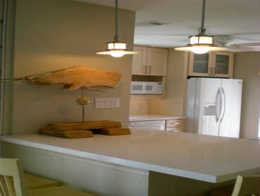 Beach House Kitchen Design This Galveston beach house kitchen captures the ambiance of the seaside while providing additional storage, countertop work 