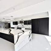 Luxury Kitchen - Bookmatched Stone Island & Custom Black Cabinetry, Fort Lauderdale