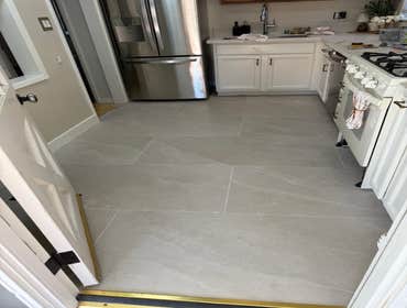 Photos by Fresh Start Renovations LLC #3 Large Format Tile Installation: Kitchen & Dining Area
Installation of large-format tiles with a critical focu