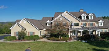 Exterior Photos Exterior painting of a large home in Bucks County, PA. Included painting of stucco siding using an elastomeric coating, as well as pain