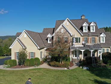 Exterior Photos Exterior painting of a large home in Bucks County, PA. Included painting of stucco siding using an elastomeric coating, as well as pain