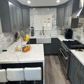 Kitchen Remodel In Los Angeles Ca Dark Gray Shaker Cabinets with Calacata Rocky Quartz & Marble 6X12 Full Backsplash