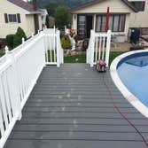 Photos by DJI Inc #1 Approximately 26'x20' deck around pool. Vinyl rails and composite decking