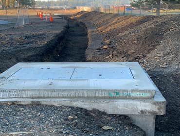 Photos by Top Grade LLC (Electrical) Excavation for electrical duct bank in poured concrete for high voltage power.