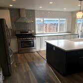 Photos by Currier Construction Co #1 Remove 2 walls to open kitchen, re design the layout, install new window and slider door, new tile flooring throug