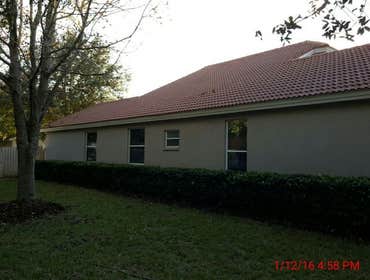 Photos from Popa Construction LLC Before & Afters of a soft wash roof cleaning and driveway and side walk cleaning.