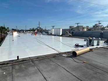Pines Plaza - PVC Recovery Over Existing Modified Bitumen RECOVERING EXISTING MODIFIED BITUMEN SYSTEM WITH SINGLE PLY PVC SYSTEM
