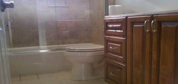 P.Garcia Remodeled bathroom, new tub and tile, new cabinet and Quartz (Cambria ) counter top, new toilet, new 3/8" thick shower doors, We saved the ori