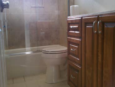 P.Garcia Remodeled bathroom, new tub and tile, new cabinet and Quartz (Cambria ) counter top, new toilet, new 3/8" thick shower doors, We saved the ori