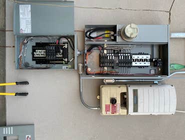 New Service upgrade with Solar ready 40 circuit panel, 200 amp metered Panel with amp125 amp sub- panel below and mounted solar inverter to roof panels