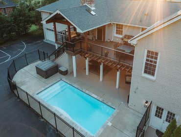 Timber Frame Covered Porch This timber-frame porch transforms a standard backyard into an elevated outdoor living space, seamlessly extending the home’