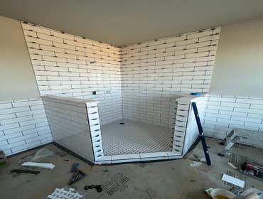 Photos by Jaxson Floor & Remodeling LLC #2 Added a walk in corner shower and chair rail tile