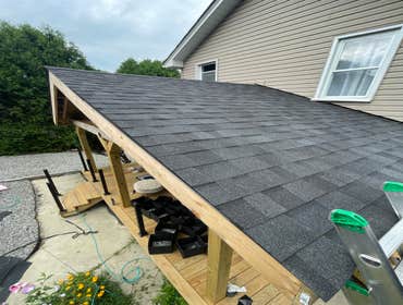 Photos by Us Success Properties LLC #1 Construction of a new roof structure over an existing residential deck. Scope of work included installation of s