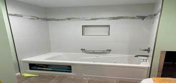 Flooring & Home Solutions LLC Bathroom with jacuzzi tub and heater