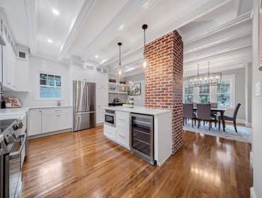 Photos by LCG BOSTON LLC #1 Full Home Remodel. Bathroom with custom glass, kitchen remodel with a beautiful exposed brick.