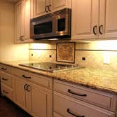 Photo(s) from Wagner Tile & Plumbing Kitchen-Dove White Cabinets, Granite Counters, Porcelain Tile Backsplash