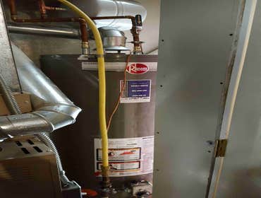 Water heater with water alarm