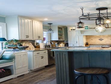 Meadville Two Tone This is a beautiful kitchen with Aurora White Perimeter Cabinets and Two Cherry Islands. All work from design to install of everyth
