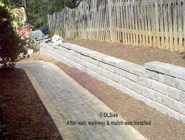 David L. Sisk Landscape & Home Services Project Exterior projects: stone patio near a waterway, new stone walkway and retaining wall with new wood fenc