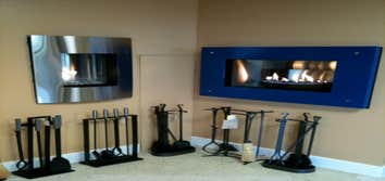 Contemporary Fireplaces Left: Nicollet direct vent gas fireplace by Kozy Heat with Brushed Stainless Steel Convex Faceplate and H20 Glass Ember Media; 