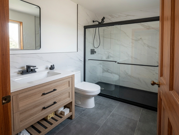 Bathroom Remodel This bathroom remodel showcases a clean, contemporary design with timeless finishes and practical functionality. The space features a 