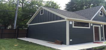 Photos by A-Windy City Garage Corporation #2 New garage construction with storage loft with built in stair case. Hardie Siding and upgraded overhead do