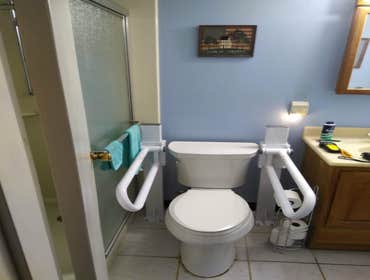Photos by Get A Grip Bath Safety #2 Health Craft folding rails with up rite base mounted in concrete slab with ceramic tile.