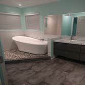 Photos by Dutch Dynasty Construction Relocate tub, walk in shower with no door, new vanity, ventilation fans, recessed lights, replace arch entry with 