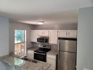 Small kitchen/bath, etc update Installed granite countertop and painted kitchen cabinets, updated sink, painted whole town house, installed laminate fl
