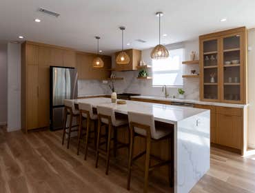 Lull Full House Remodel Explore our completed kitchen remodel with a warm, inviting ambiance, featuring sleek wooden cabinetry, elegant marble countert