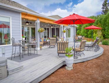 Trex Deck with Bowfront and Shed Cover Going the length of the backyard, this Trex Transcends deck features a hot tub with Trex bench and step, an exte