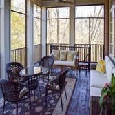Screened Porch All cedar handrails and frame with hand-made laminated arches to maintain the beautiful, uncluttered view from inside.