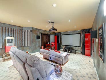 Custom In-Home Theater Custom family theater room. Each detail was perfectly installed from the stadium flooring, blackout curtains, projector placemen
