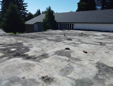 Isaac Roof Construction Commercial Roof Project Flat roof replacement with a minimum R-value of R-30 and a Class A Fire rating.