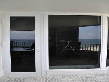 The Claridge Condo - Installation Removed non-impact windows and doors and replaced with impact windows and doors.