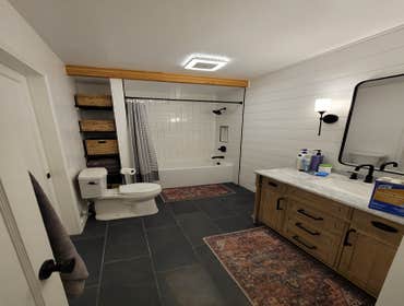 Nikki - Bath Renovated entire layout of the room by moving all the plumbing, added a door and storage on the other side of the wall (in the bedroom), a