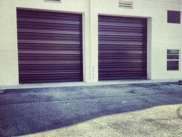 repainting warehouse in Hialeah Pressure washed, one coat of primer two coats of paint